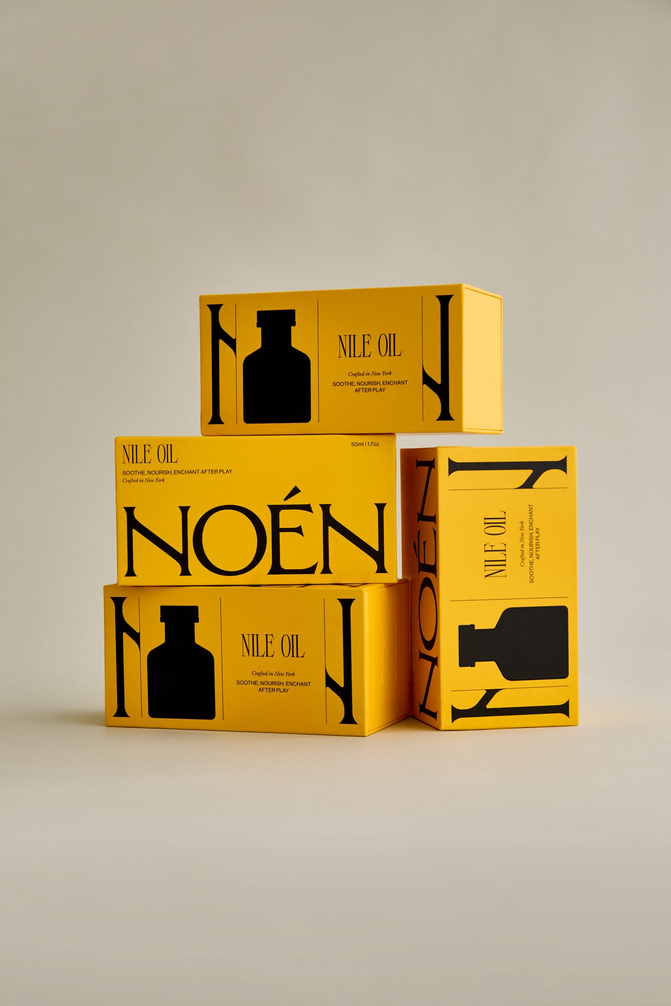 A collection of Noén Afterplay Oil product boxes. Each box contains a luxurious afterplay oil, formulated with a blend of natural ingredients, including beta-caryophyllene, calendula, moringa, buriti fruit, and rosemary, to soothe, rejuvenate, and revitalize intimate skin, different than a lubricant.