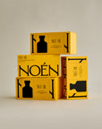 A collection of Noén Afterplay Oil product boxes. Each box contains a luxurious afterplay oil, formulated with a blend of natural ingredients, including beta-caryophyllene, calendula, moringa, buriti fruit, and rosemary, to soothe, rejuvenate, and revitalize intimate skin, different than a lubricant.