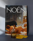 A bottle of Noén with their magazine and travel size sachets.