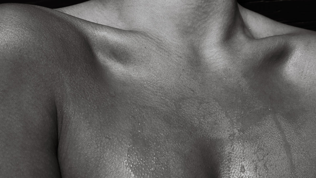 Black and white close-up of collarbones and skin