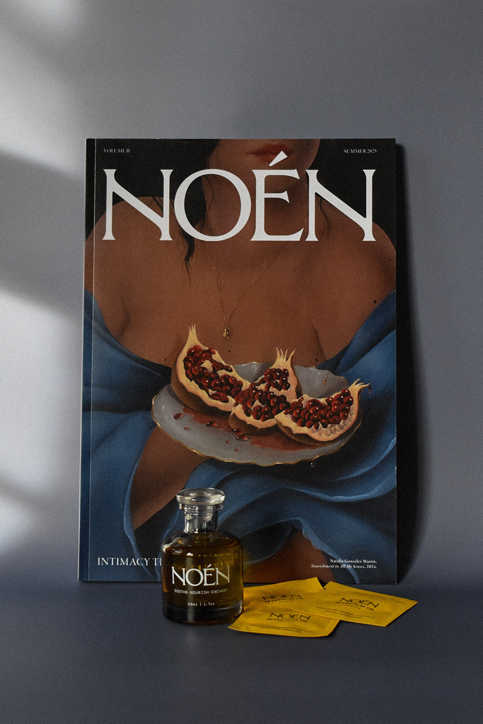 A bottle of Noén with their magazine and travel size sachets.