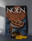 A bottle of Noén with their magazine and travel size sachets.