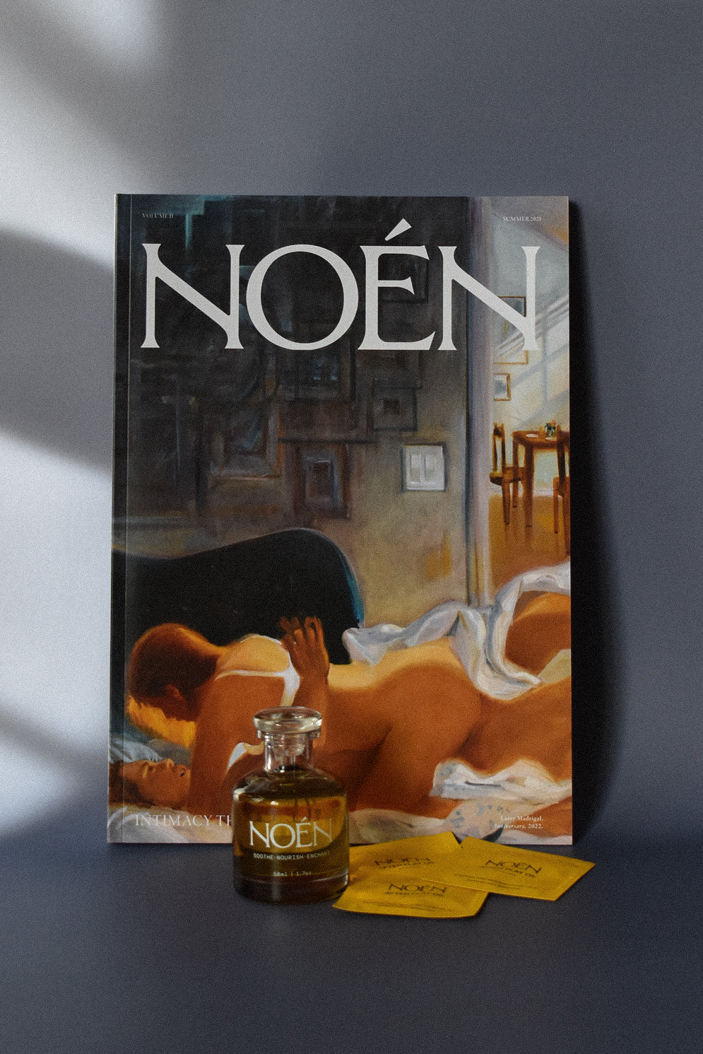 A bottle of Noén with their magazine and travel size sachets.
