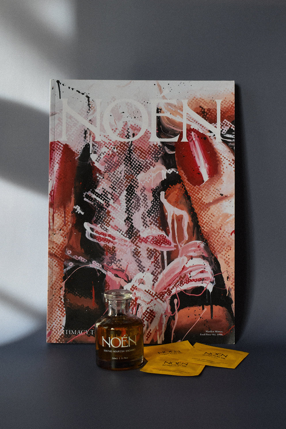 A bottle of Noén with their magazine and travel size sachets.