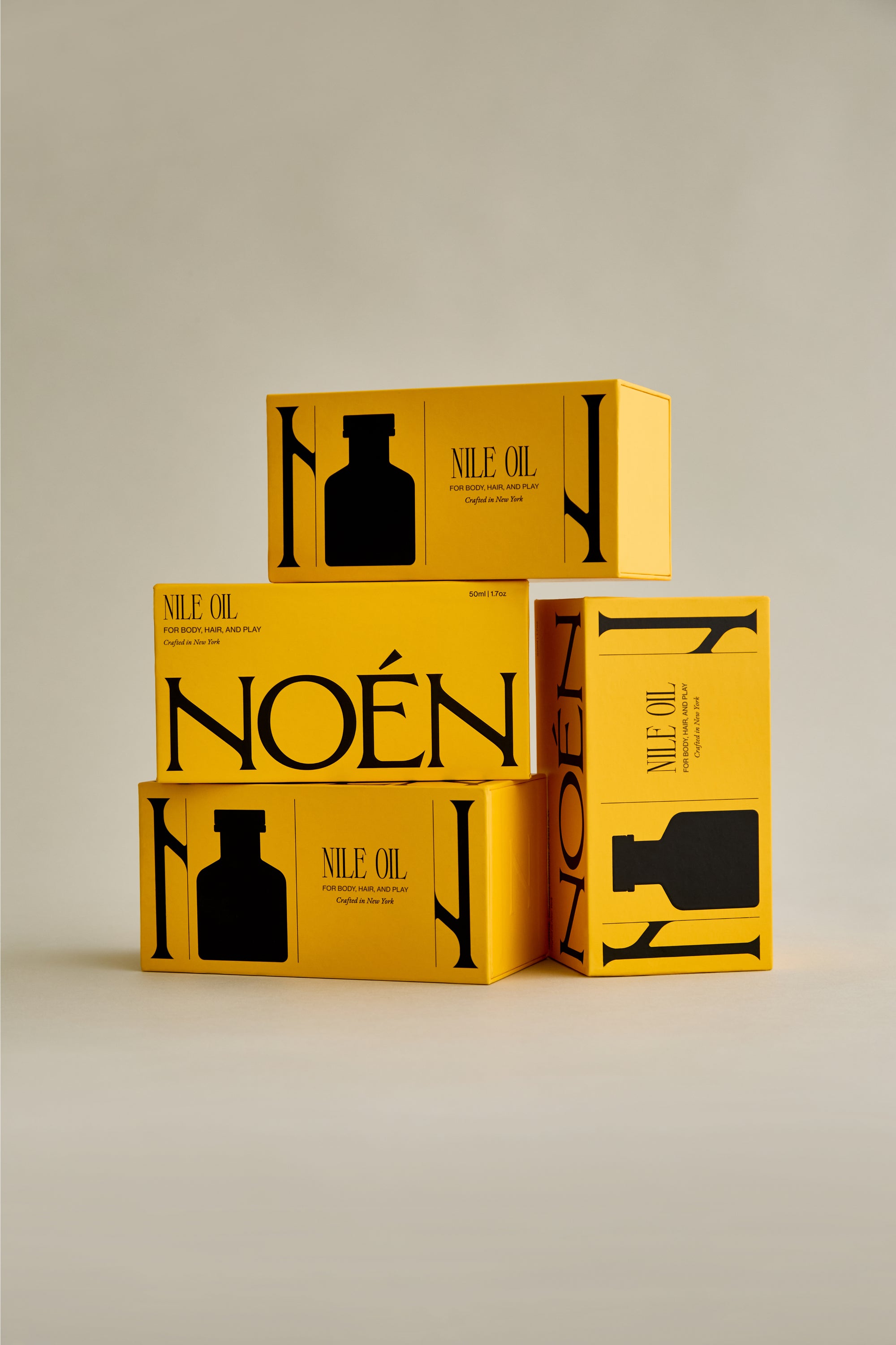 A collection of Noén Afterplay Oil product boxes. Each box contains a luxurious body oil, formulated with a blend of natural ingredients, including beta-caryophyllene, calendula, moringa, buriti fruit, and rosemary, to soothe, rejuvenate, and revitalize intimate skin, body, and hair.