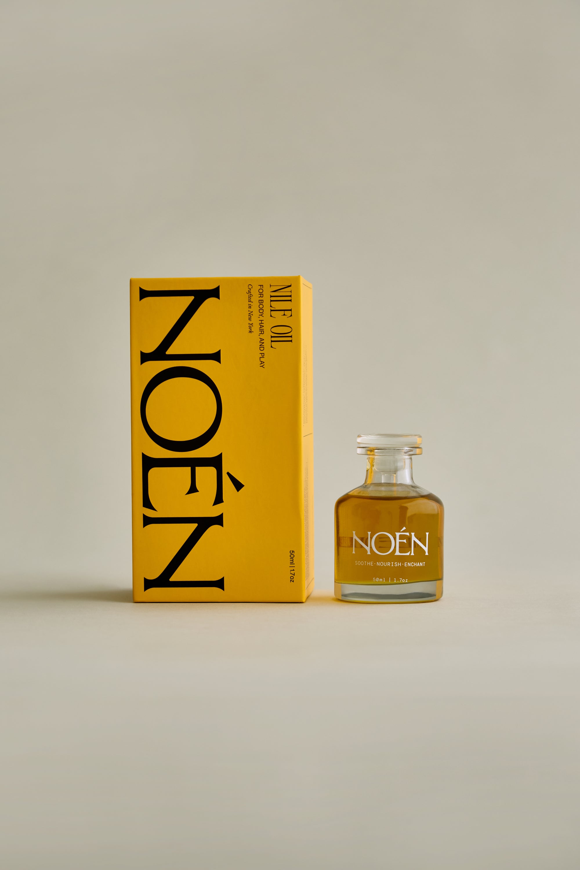 A bottle of Nile Oil by Noén, a luxurious intimacy oil formulated with a blend of natural ingredients including beta-caryophyllene, calendula, moringa, buriti fruit, and rosemary. This soothing and rejuvenating oil is designed to hydrate, calm, and revitalize the body, hair, and intimate parts after sex, after sun, or after shower.