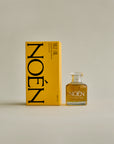 A bottle of Nile Oil by Noén, a luxurious intimacy oil formulated with a blend of natural ingredients including beta-caryophyllene, calendula, moringa, buriti fruit, and rosemary. This soothing and rejuvenating oil is designed to hydrate, calm, and revitalize the body, hair, and intimate parts after sex, after sun, or after shower.