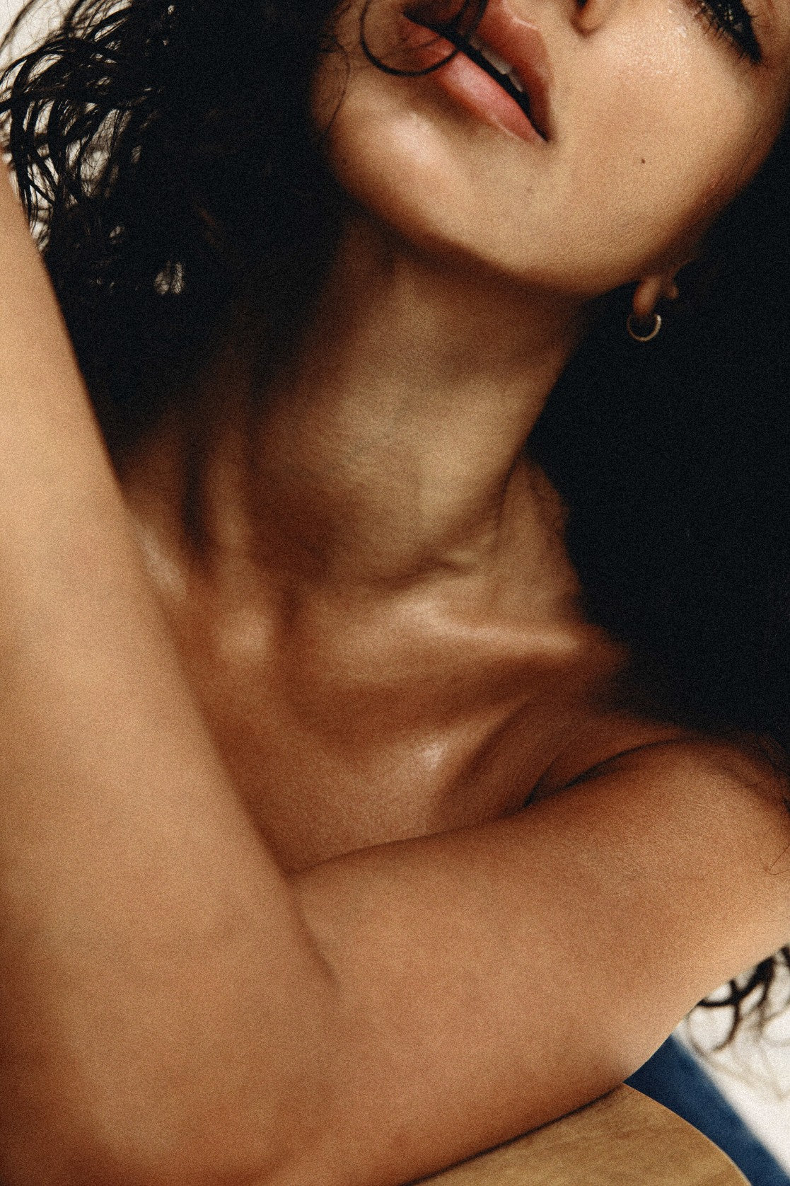 Woman with dark hair, arm across her chest